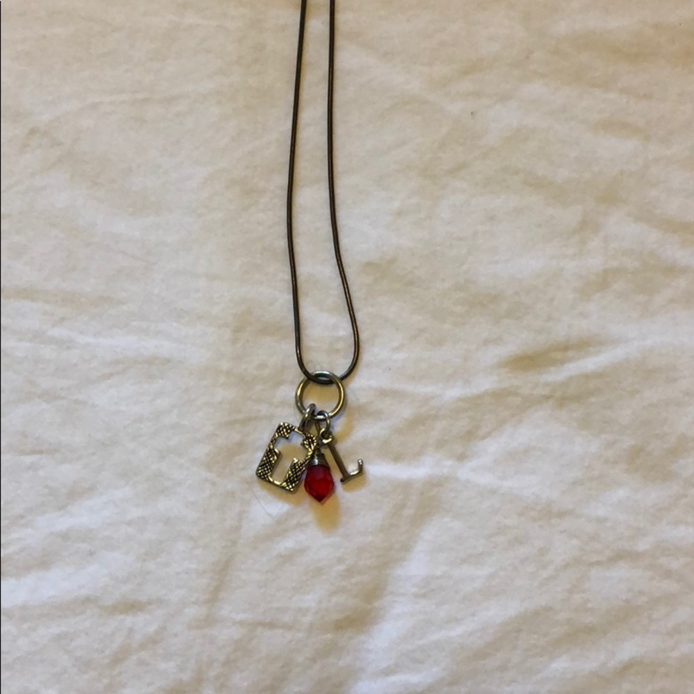 L cross red gem necklace